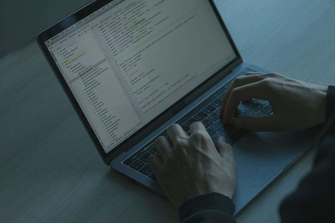 a person typing on their keyboard.